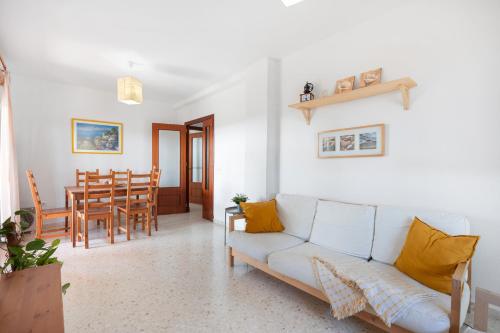 a living room with a couch and a table at Camaleón 7 in Chipiona