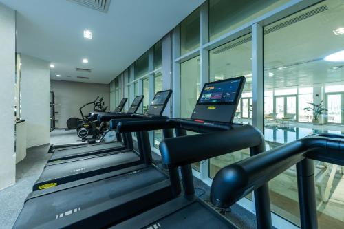 a row of treadmills in a gym with a laptop at Cleopatra Sidi Heneish in Marsa Matruh