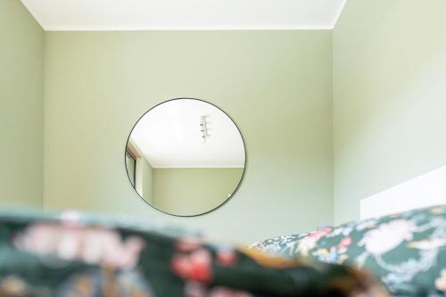 a mirror hanging on a wall next to a couch at Hafen 6 in Zwenkau