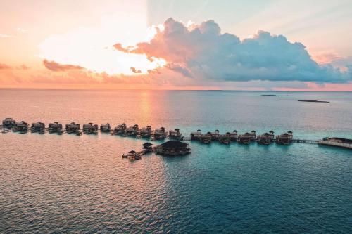 an aerial view of a dock in the water at Angsana Velavaru in Dhaalu Atoll