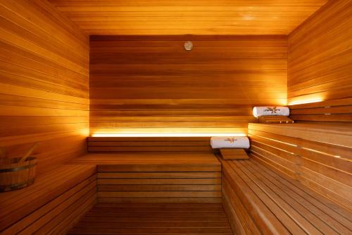 a sauna with wooden walls and a bench in it at Cleopatra Sidi Heneish in Marsa Matruh