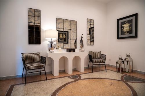 a living room with a table and two chairs at La Corte di Partenope Luxury Suite in Naples