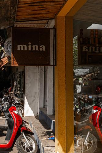 a red scooter parked in front of a store at Eiwa House in Ubud