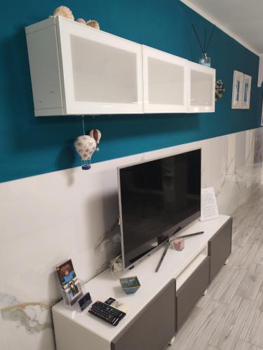 a living room with a large monitor on a desk at La CasAffittiera Apartments Group in Anzio