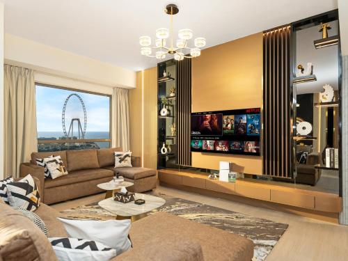 a living room with a couch and a large window at Dubai Eye & Palm View #JBR Beach # ULTRA Luxurious 2 BHK in Dubai