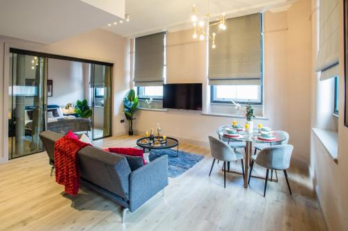 a living room with a couch and a table at Stylish Manchester City Escape - Walk to Chinatown in Manchester
