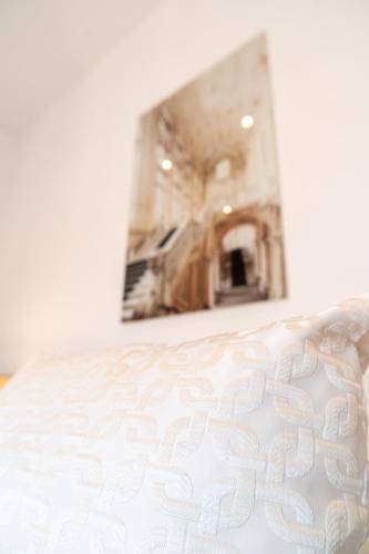 a white bed in a room with a mirror at La Corte di Partenope Luxury Suite in Naples