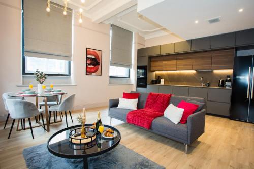 a living room with a couch and a table at Stylish Manchester City Escape - Walk to Chinatown in Manchester