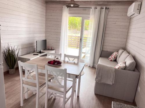 a living room with a table and a couch at Casa Silva in Zambujeira do Mar