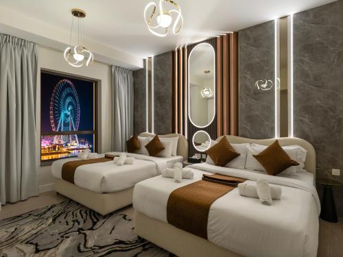 a hotel room with two beds and a tv at Dubai Eye & Palm View #JBR Beach # ULTRA Luxurious 2 BHK in Dubai