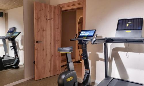 a room with a gym with a treadmill and a computer at Nomad Hotel & Spa Altea in Altea