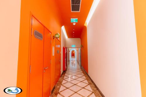 an orange hallway with orange walls and a tile floor at Oscar Seaview Apartment in Phu Quoc