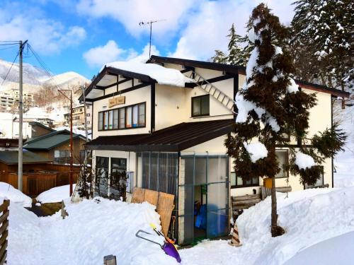 a house with snow on the ground in front of it at Winter Season - 民泊 Matsuo House in Zao Onsen - Japanese Style - Private Room in Zao Onsen