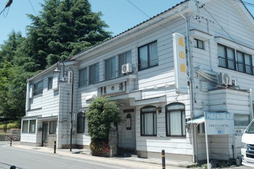 a white building on the corner of a street at Law Firm ローファーム in Nagano