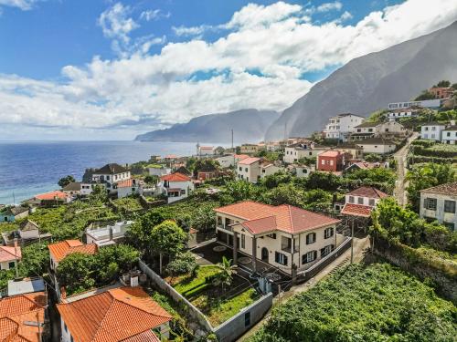 an aerial view of a town with the ocean at MadeiraLife in Seixal