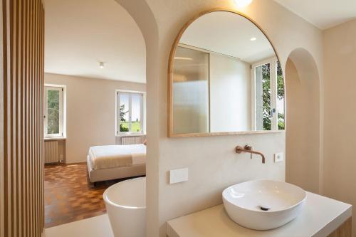 a bathroom with a sink and a mirror at Il Belcanto Villa with Pool in Cavaion Veronese