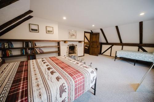a bedroom with a large bed and a fireplace at 13 Beds, 17 Guests with Hot tub only 15Mins to Sunday River in Newry