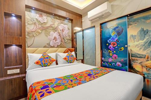 a bedroom with a bed and a painting on the wall at FabHotel Saravana Shelters Residency - Nr Tambaram Railway Station in Chennai