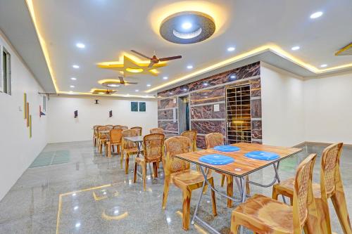 a dining room with a table and chairs at FabHotel Saravana Shelters Residency - Nr Tambaram Railway Station in Chennai