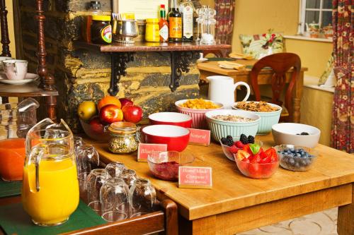 a table with fruits and other food items on it at Tinhay Mill in Lifton