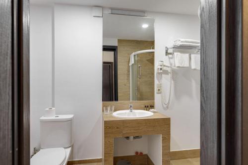 a bathroom with a toilet and a sink at Hotel Mevora in Tbilisi City