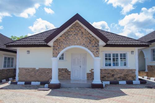 a brick house with a white door at Residential Quarters in Oshogbo