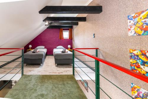 a room with four beds and purple walls at Apartamenty za Leśniczówką in Stegna