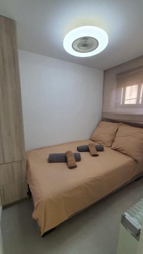 a bedroom with a large bed with a frisbee on the ceiling at Apartament PREMIUM in Torrevieja