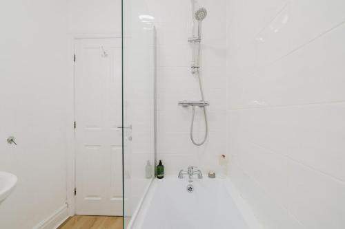 a shower with a glass door in a bathroom at Modern 2 Bed Apt with Roof Terrace - Ecclesall Rd - Now Hosted by StayHostSave in Sheffield