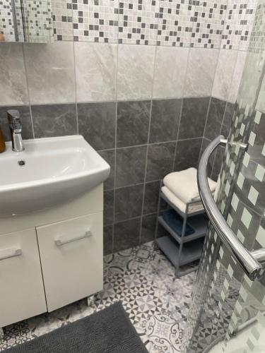 a bathroom with a sink and a shower at Bytík pod Tatrami - Svit in Svit