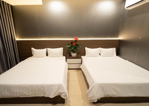 two beds sitting next to each other in a room at Ngoc Se Hotel in Pleiku