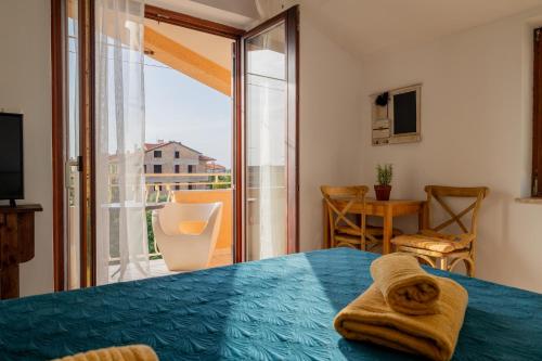 a bedroom with a bed and a large window at Casa Botin in Rovinj