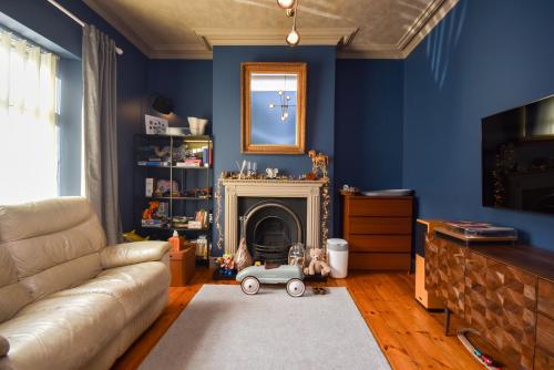 a living room with a couch and a fireplace at Cardiff Townhouse in Cardiff