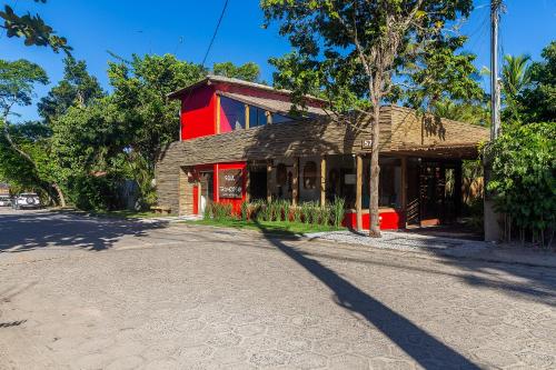 a red building on the side of a street at Soul Trancoso - Hotel Boutique in Trancoso