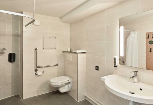a bathroom with a toilet and a sink at B&B HOTEL Paris Romainville Noisy-le-Sec in Romainville