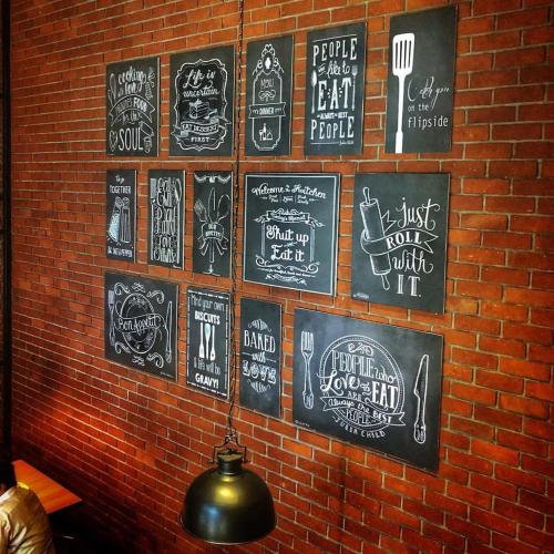 a wall with chalk drawings on a brick wall at Weekend Address in Dumas