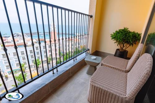 a room with a balcony with a view of the ocean at Oscar Seaview Apartment in Phu Quoc