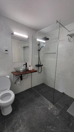 a bathroom with a toilet and a glass shower at Hanapartment 3 bed Ayia NAPA in Ayia Napa