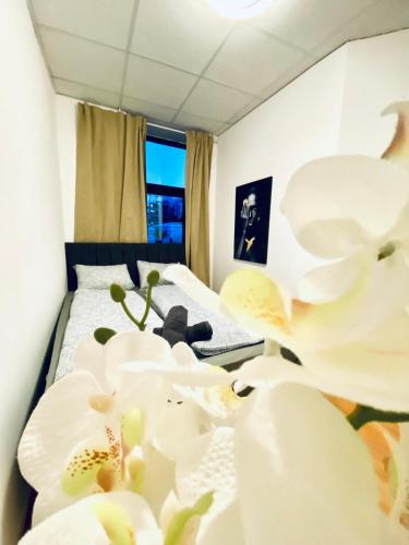 a bedroom with a bed with white flowers on it at Sweet 3-Bedroom shared Apartment in a Quiet Neighborhood in Vienna