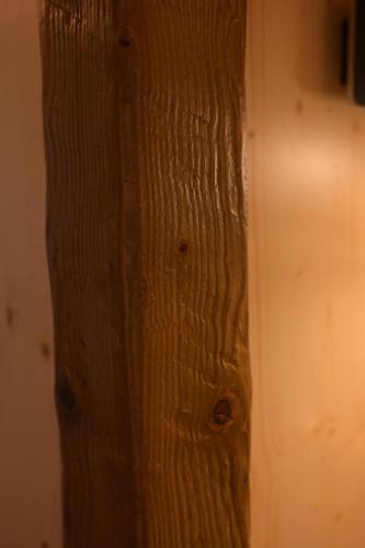a close up of a wooden pole in a room at Chalet by Provence Suceava in Suceava