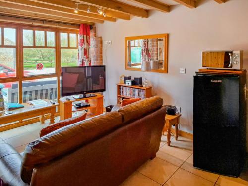 a living room with a couch and a television at Gull Newk in Flamborough