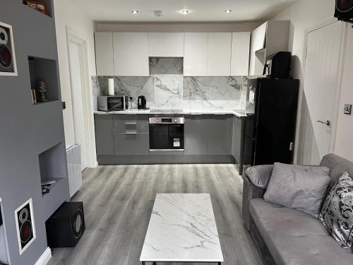 a living room with a couch and a kitchen at Private 2 bed Apartment - Edinburgh - Sleeps 2 Max in Edinburgh