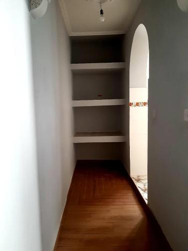 an empty room with a hallway with wooden floors at Dar yahya in Chefchaouene