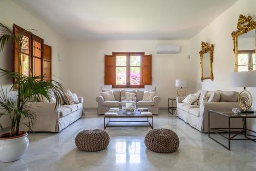 a living room with two couches and a table at Il Giardino di Venere in Mondello