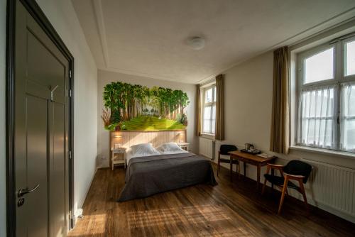 a bedroom with a bed and a painting on the wall at Herberg de Brabantse Kluis in Aarle-Rixtel