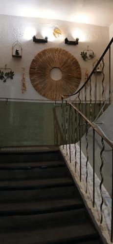 a stairway with a large circular mirror on the wall at Hôtel Saint Florent in Orange