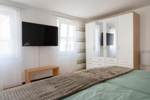a bedroom with a bed and a flat screen tv at Hotel Ochsen in Bad Saulgau