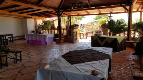 a large room with two tables and chairs in it at Agriturismo Duca di San Martino in Partanna