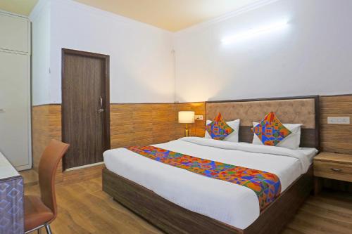 a bedroom with a large bed in a room at FabExpress Vasant Villa - Near ILBS Hospital in New Delhi