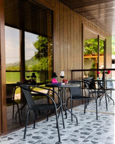 a group of chairs and tables on a patio at Askrioni - ასკრიონი 